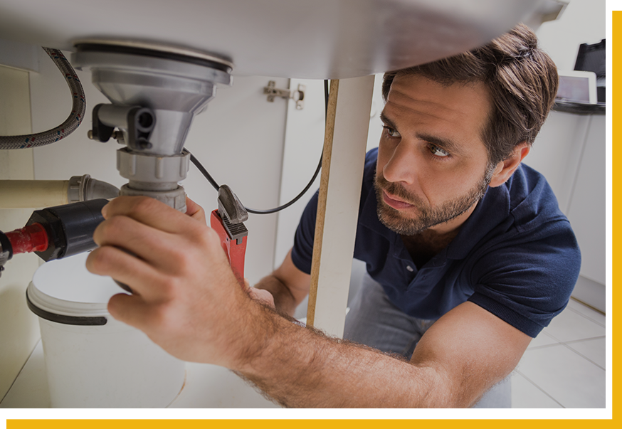 plumber working on a sink