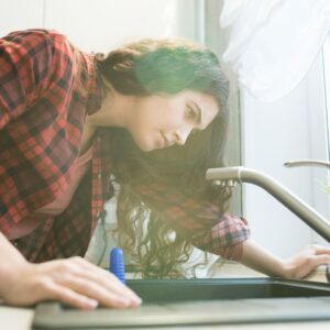 img of a woman looking at a sink